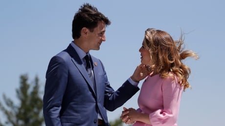 Canadian Prime Minister Justin Trudeau and his wife Sophie Gregoire Trudeau talk prior to the beginning of a welcoming ceremony during the G7 Summit, Friday, June 8, 2018, in Charlevoix, Canada.